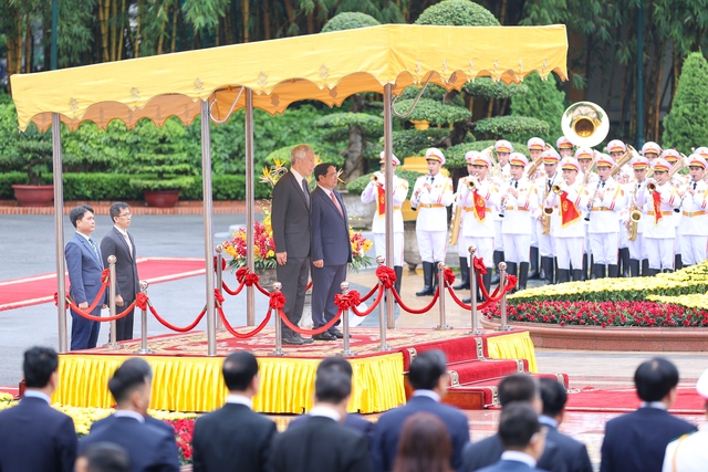 Photos: Vietnamese Prime Minister hosts official welcome ceremony for Singaporean counterpart - Ảnh 2.