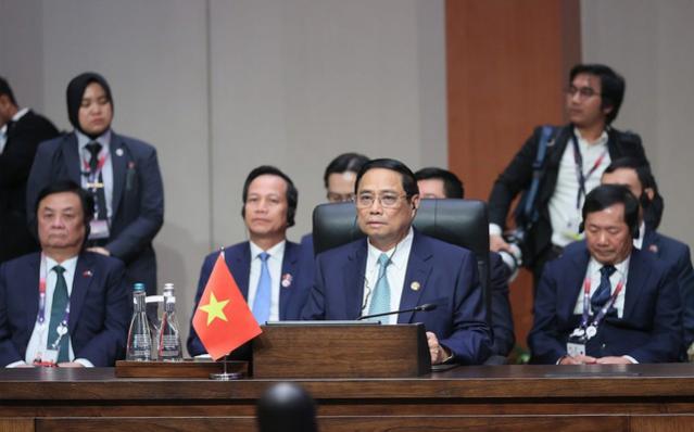 越南政府总理范明正出席东盟-印度领导人会议和东亚峰会 - Ảnh 1.