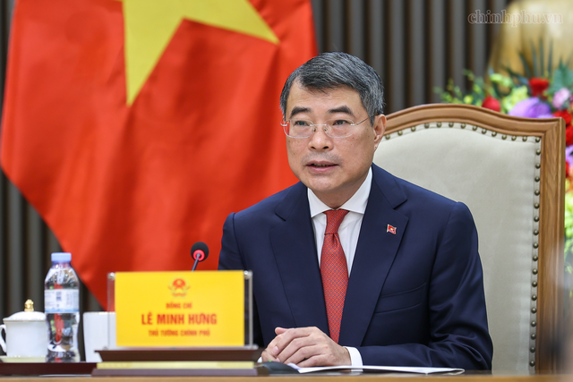 Prime Minister Le Minh Hung holds phone conversation with German Chancellor Friedrich Merz- Ảnh 1.