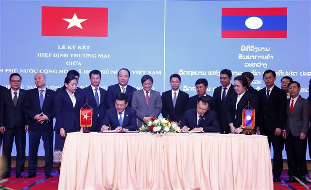 越南与老挝签署新贸易协定- Ảnh 1.