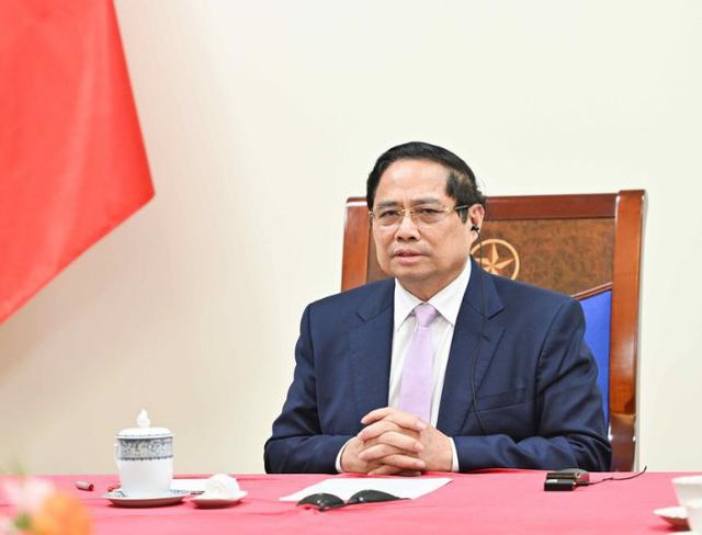 越南政府总理范明正与马来西亚总理安瓦尔•易卜拉欣通电话- Ảnh 1.